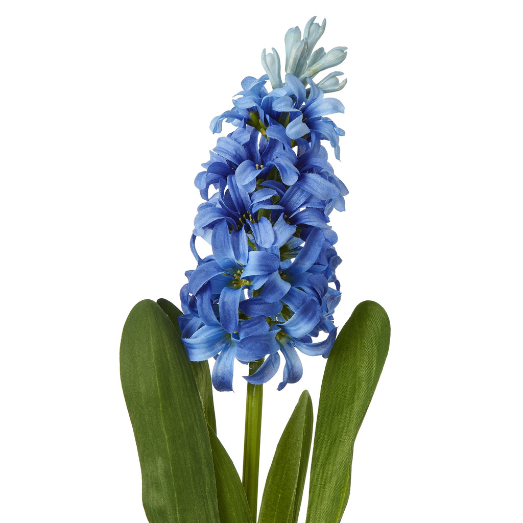 Close-up of curved blue petals and pale buds at the top of the artificial flower spike, with textured green leaves below.