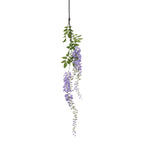 Artificial flower spray hanging against white, with a long dark stem, green leaves and trailing lavender-purple flower clusters.