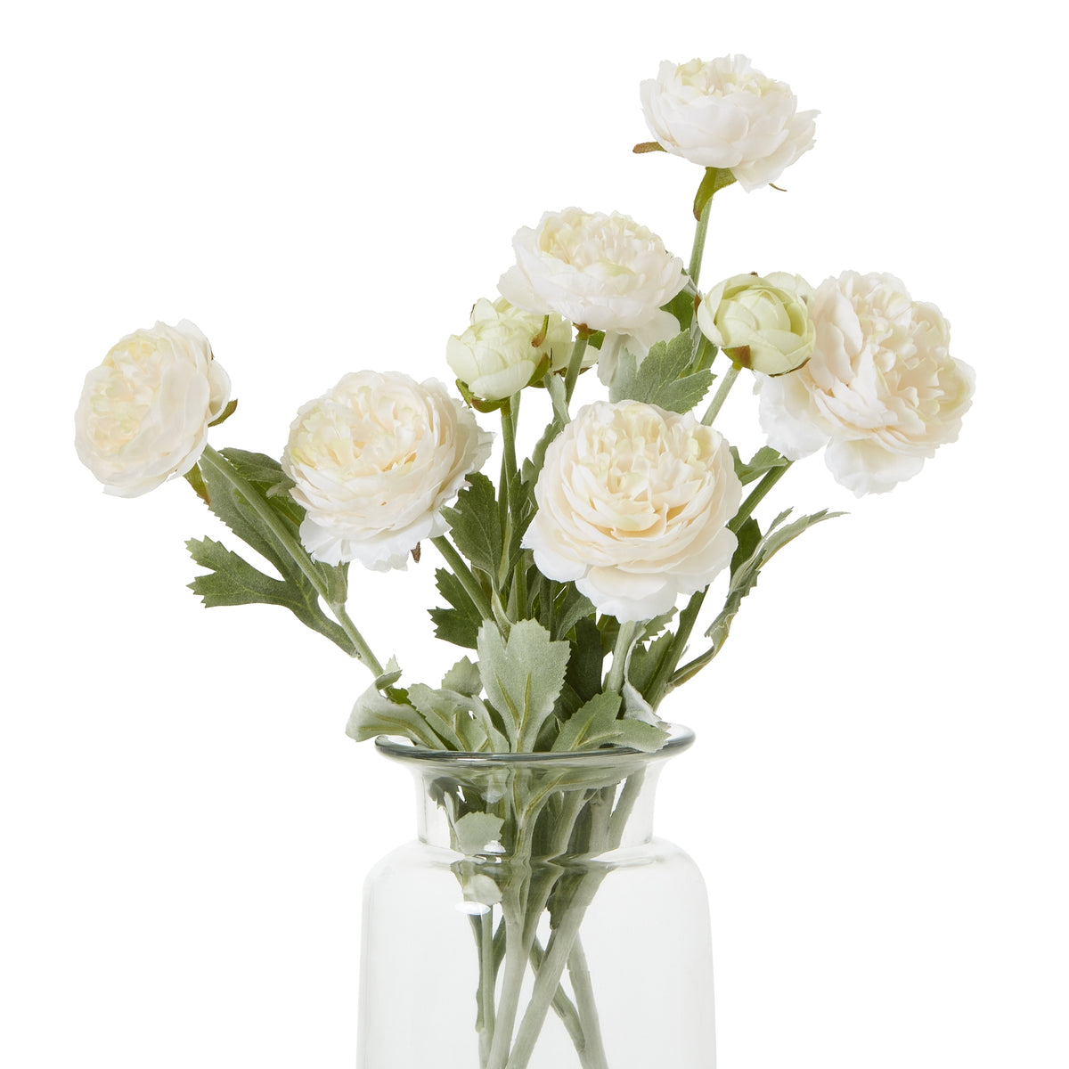 Pale cream artificial flowers with layered rounded blooms and green foliage, shown as a multi-stem arrangement in a clear vase against white.