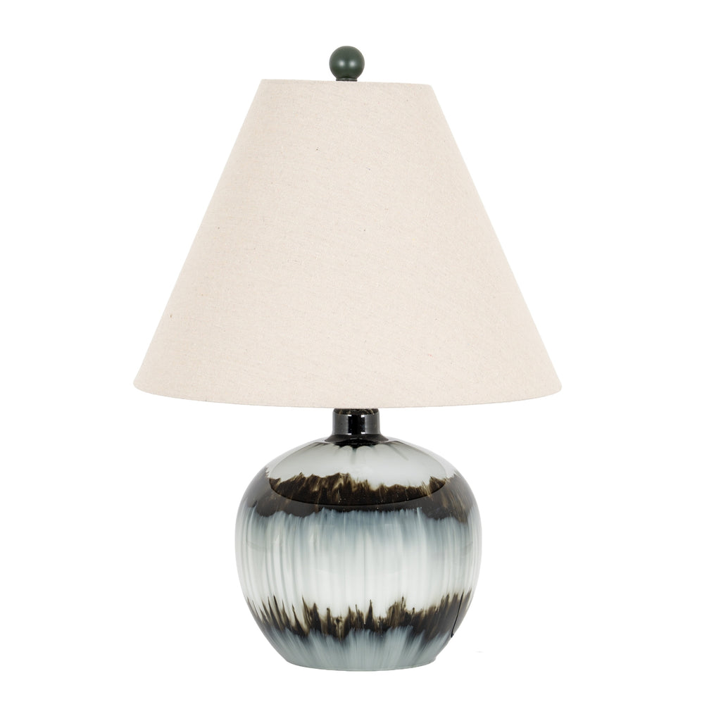 Table lamp with an off-white tapered shade, dark spherical finial and rounded glossy base patterned with pale areas and smoky bands.