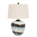 Table lamp with a pale glossy rounded base, two irregular dark bands, an off-white tapered shade and a dark ball finial against white.