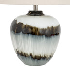 Close-up of the lamp's glossy base showing feathered brown-black bands, pale vertical streaking and a short silver-coloured neck beneath the shade.