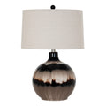 Table lamp on white with a glossy rounded taupe, cream and near-black banded body, pale tapered shade and dark ball finial.