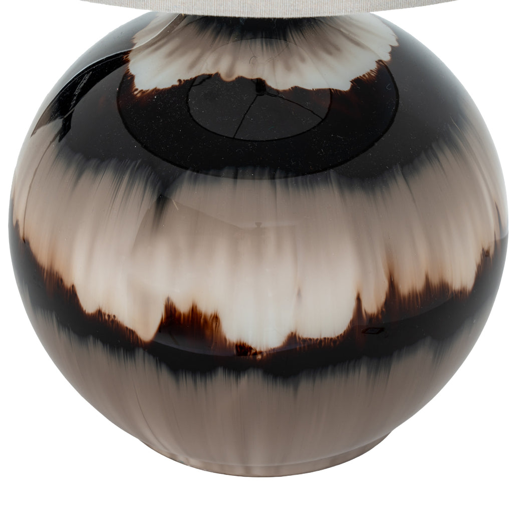 Close-up of the glossy lamp body showing feathered cream and smoky taupe bands bordered by near-black, beneath the shade edge.