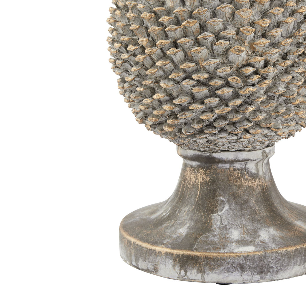Detail of the lower pinecone scales above a curved pedestal with mottled grey-white colouring and golden marks.