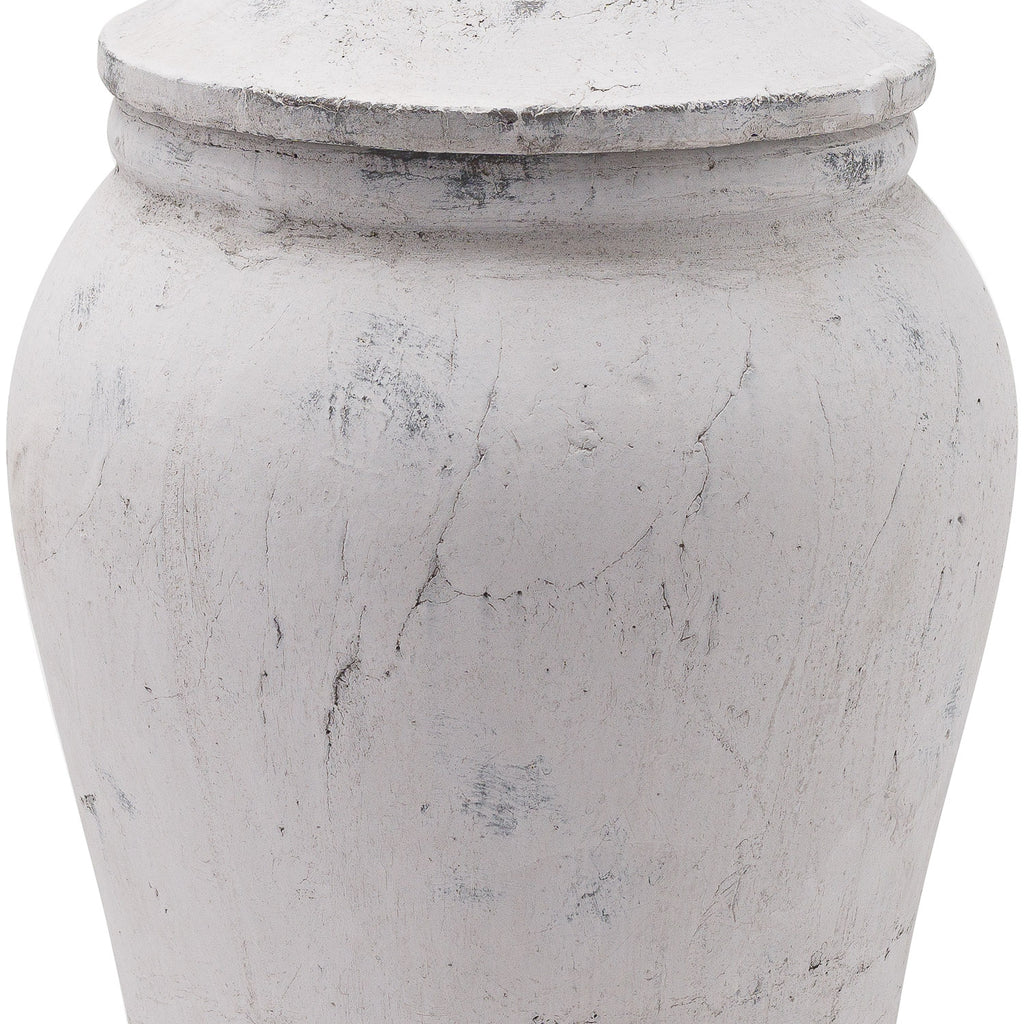 Close-up of the ginger jar's lid edge and rounded shoulder, showing crackled lines and darker scuffed patches across the pale finish.