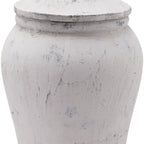 Close-up of the ginger jar's lid edge and rounded shoulder, showing crackled lines and darker scuffed patches across the pale finish.