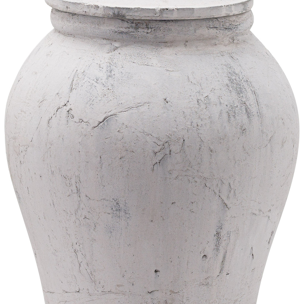Close-up of the ginger jar's curved body and lid edge, showing irregular crackled markings and darker grey scuffs in the pale finish.