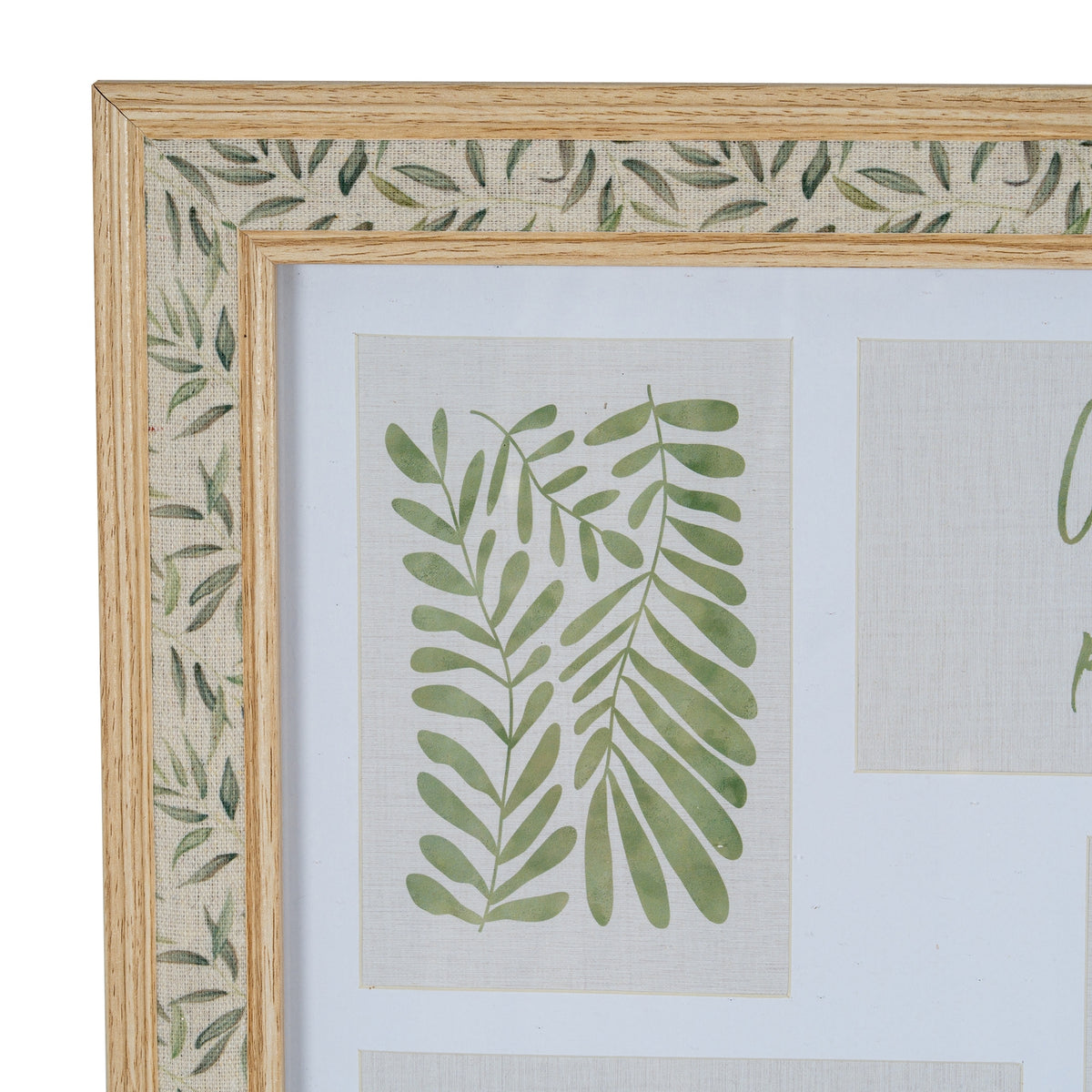 Close-up of the frame's upper left corner, showing the green leaf print on a textile-like pale band between two wood-tone trims and a botanical insert within the white mount.