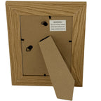 Rear view of the photo frame with a brown backing panel, fold-out stand, two hanging loops and a label warning against placement above or near a heat source.
