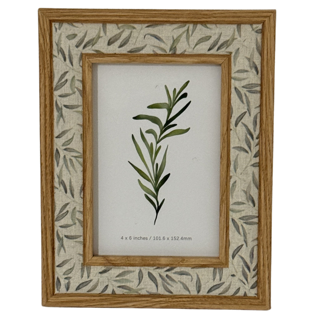 Front view of the Leafprint Doubletrim photo frame, with warm brown inner and outer trim, a pale leaf-patterned border and a botanical display insert.