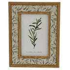 Front view of the Leafprint Doubletrim photo frame, with warm brown inner and outer trim, a pale leaf-patterned border and a botanical display insert.