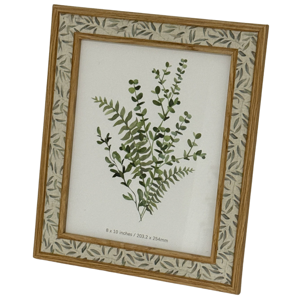Angled portrait view of the leaf-patterned photo frame, showing its inner and outer trim around a botanical placeholder marked 8 × 10 inches / 203.2 × 254mm.