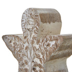 Close-up of the angel's rounded head and outspread wings, with distressed white wash around the floral and leaf relief.