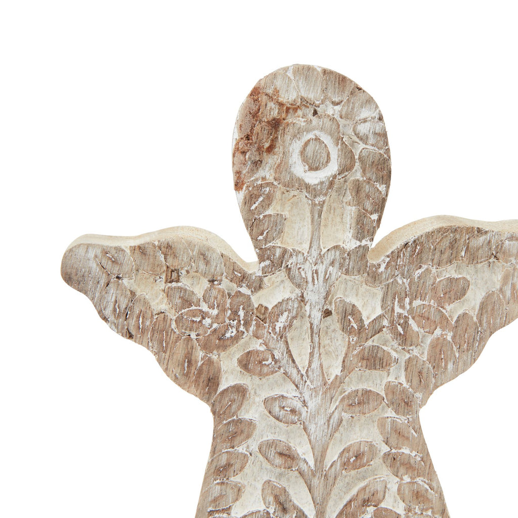 Close-up of the angel's rounded head and wings, showing a flower motif and branching leaves picked out by white accents.