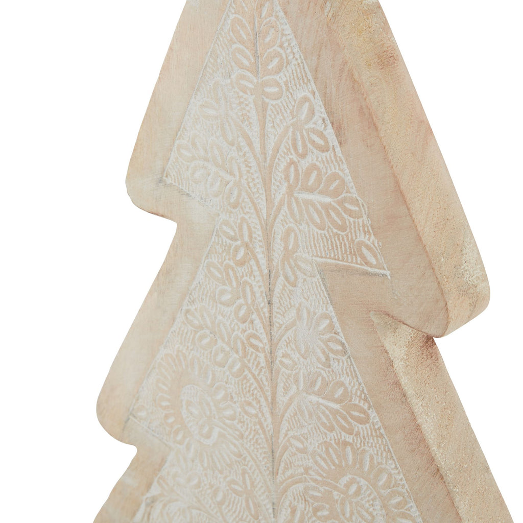 Angled close-up of the tree decoration's upper leaf pattern and broad tan border, showing the thickness of the stepped outline.