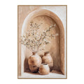 Front view of portrait artwork in a narrow golden-toned frame, showing three tan vessels beneath an arch, with leafy branches rising from the left vessel.