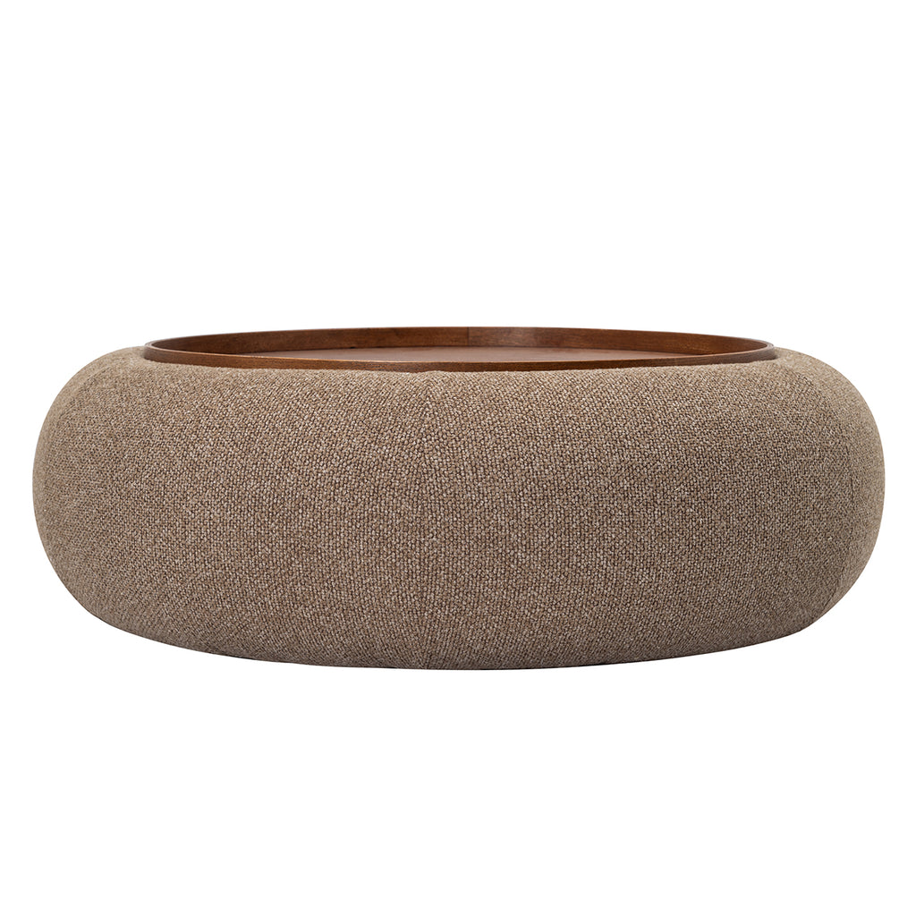 Low front view of the round coffee-coloured ottoman with textured upholstery and an inset walnut-toned tray.