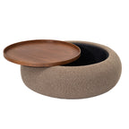 Walnut-toned tray shifted to one side of the ottoman, revealing the dark storage compartment beneath.