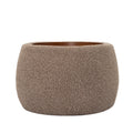 Front view of the coffee-coloured rounded storage ottoman with textured upholstery and an inset wooden tray.