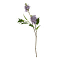 Full view of an artificial flower stem with two purple-lilac flower clusters, broad green leaves and a long brown branching stem on white.