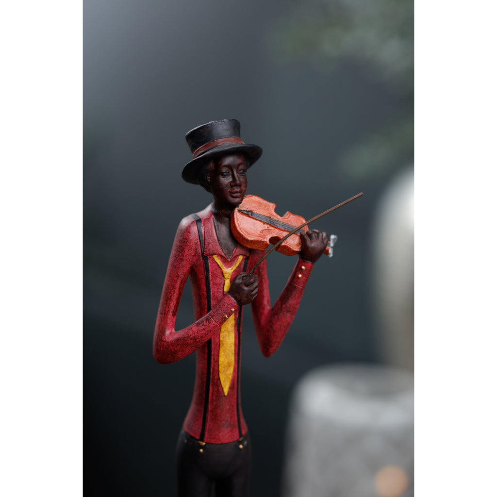 Close-up of the violinist’s face, tall hat, red shirt and yellow tie, with an orange-brown violin and diagonal bow against a blurred dark background.