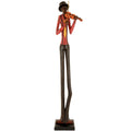 Full-length violinist figurine on a dark rectangular plinth, with very long dark trousers, a red shirt, yellow tie and tall dark hat, against white.