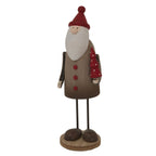 Angled view of the rustic Santa figure showing the red tree with white dots at his side, slender arms and rounded dark shoes.