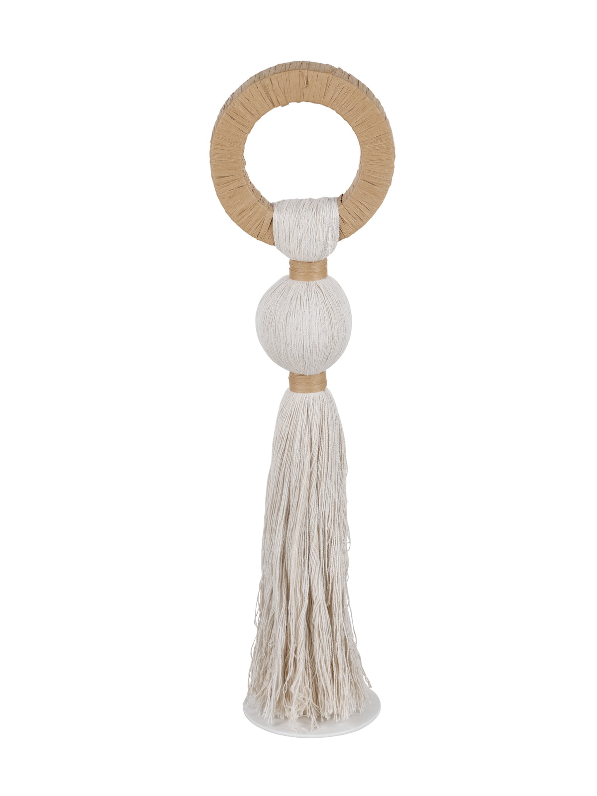 Front view of a natural-toned sculpture with a tan open loop, pale rounded rope centre and long tassel above a round pale base.