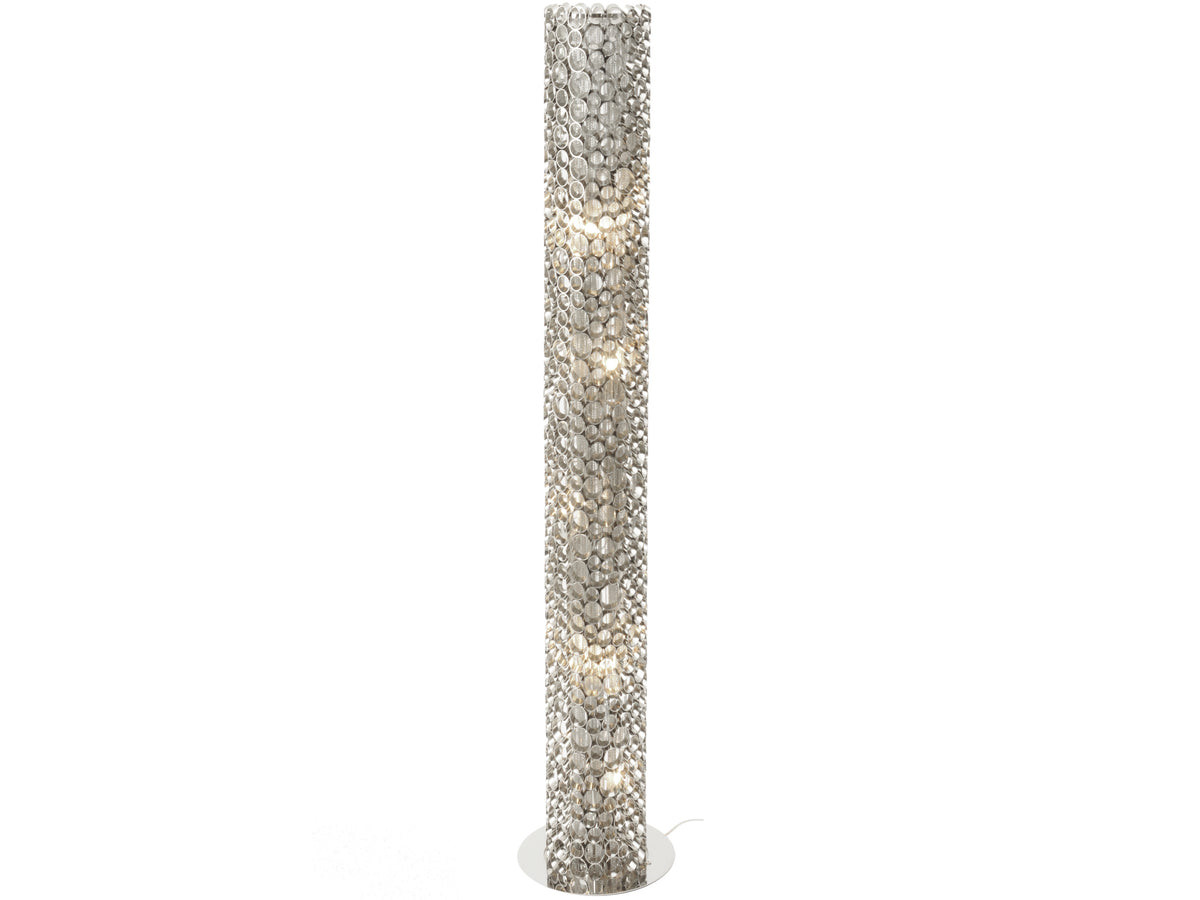 Illuminated silver-toned cylindrical floor lamp with an overlapping loop cage, fine chains inside and a circular base on a white background.