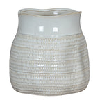 Alternate view of the rounded white vase, with its glossy patterned body and the uneven curve of its broad rim visible.