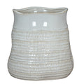 White vase on a white background, showing a wavy open rim, smooth upper band and horizontal rows of beige-accented loop impressions.