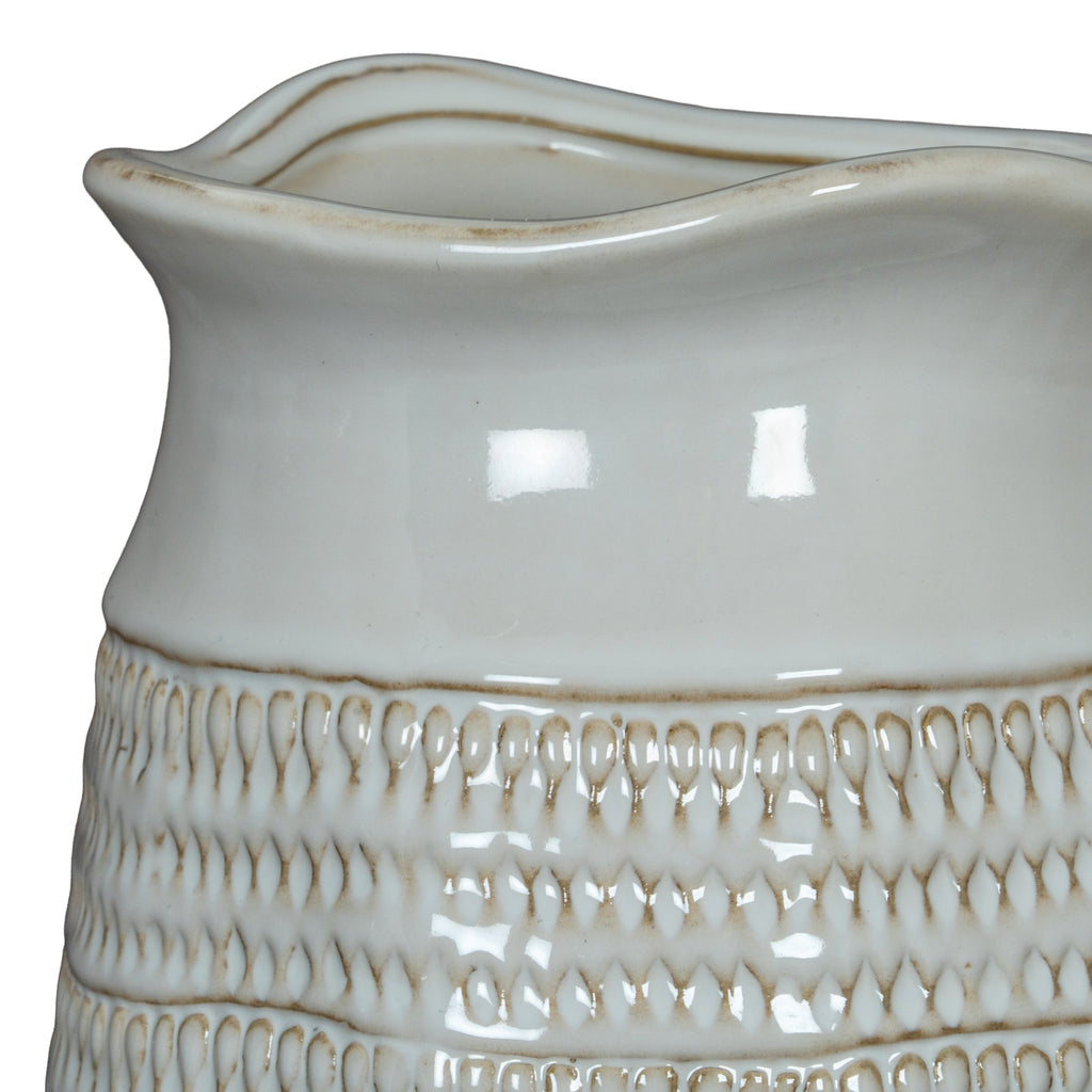 Close-up of the vase's undulating rim and glossy smooth upper band, meeting rows of small loop impressions with beige recesses.