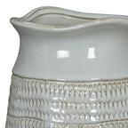 Close-up of the vase's undulating rim and glossy smooth upper band, meeting rows of small loop impressions with beige recesses.