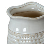 Angled close-up looking into the vase's broad wavy opening, with beige edging and a smooth white neck above the patterned body.