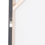 Rear detail of the canvas showing a silver-coloured fixing loop with two screws beside pale support rails and a white backing surface.