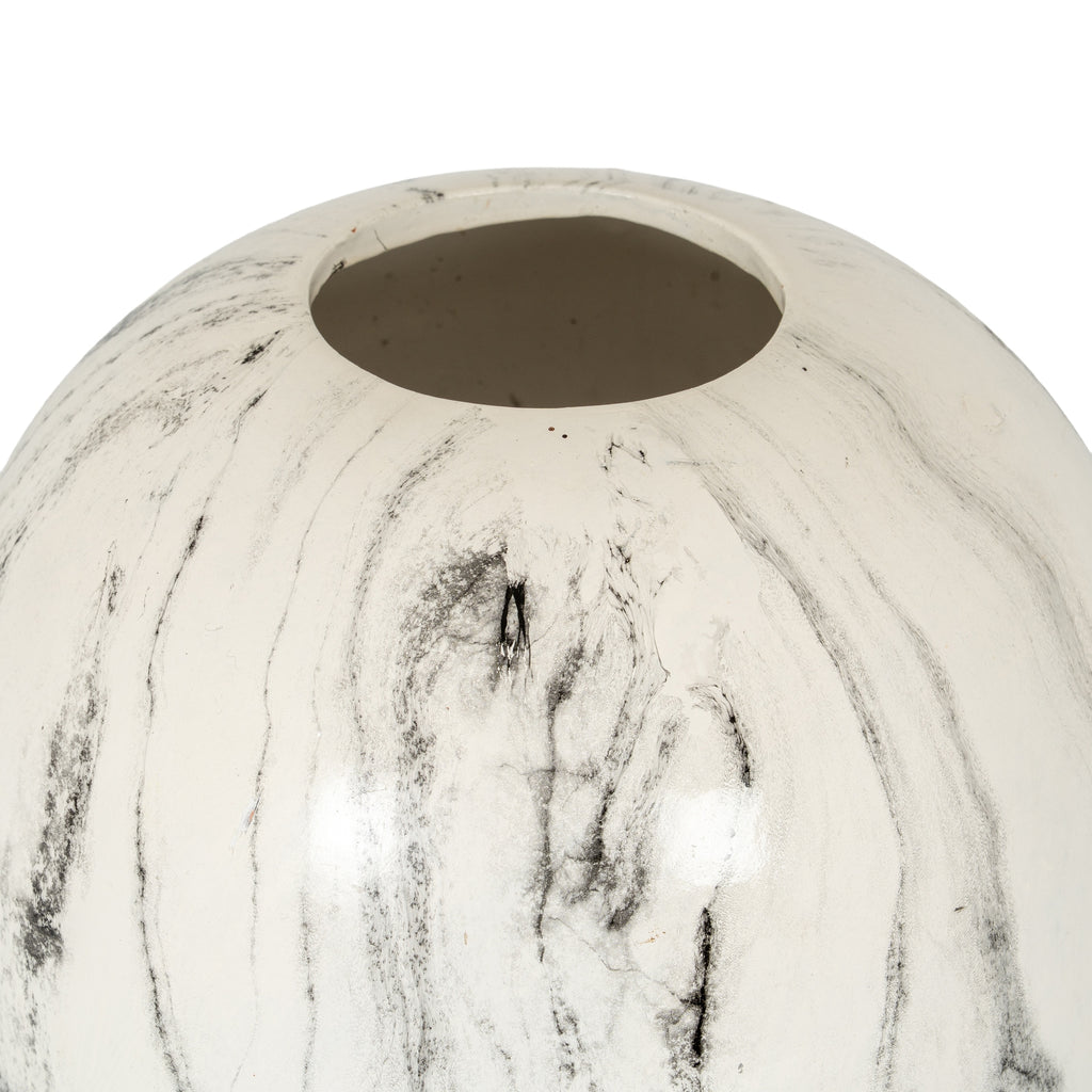 Close view of the vase's circular opening and curved shoulder, with fine grey trails and charcoal patches across the glossy off-white finish.