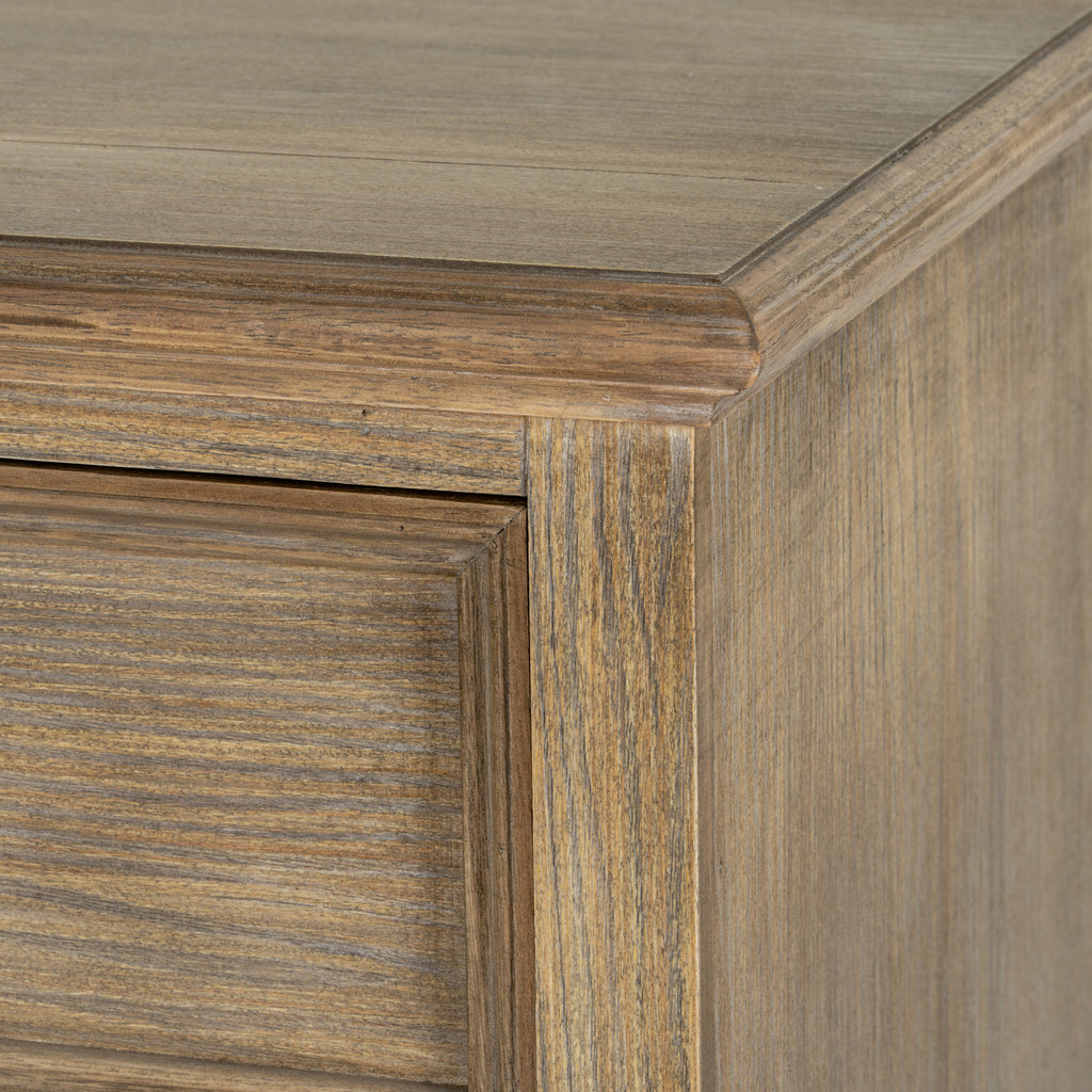 Close-up of the chest's upper corner, showing the shaped top edge and varied grain across the front and side.