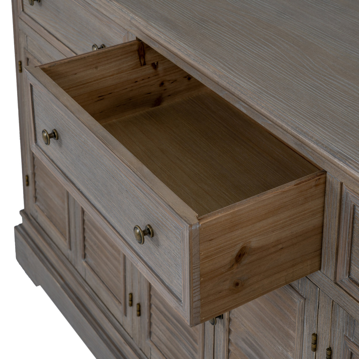 Close view from above of an open drawer, showing its empty interior, framed front and two round knobs.