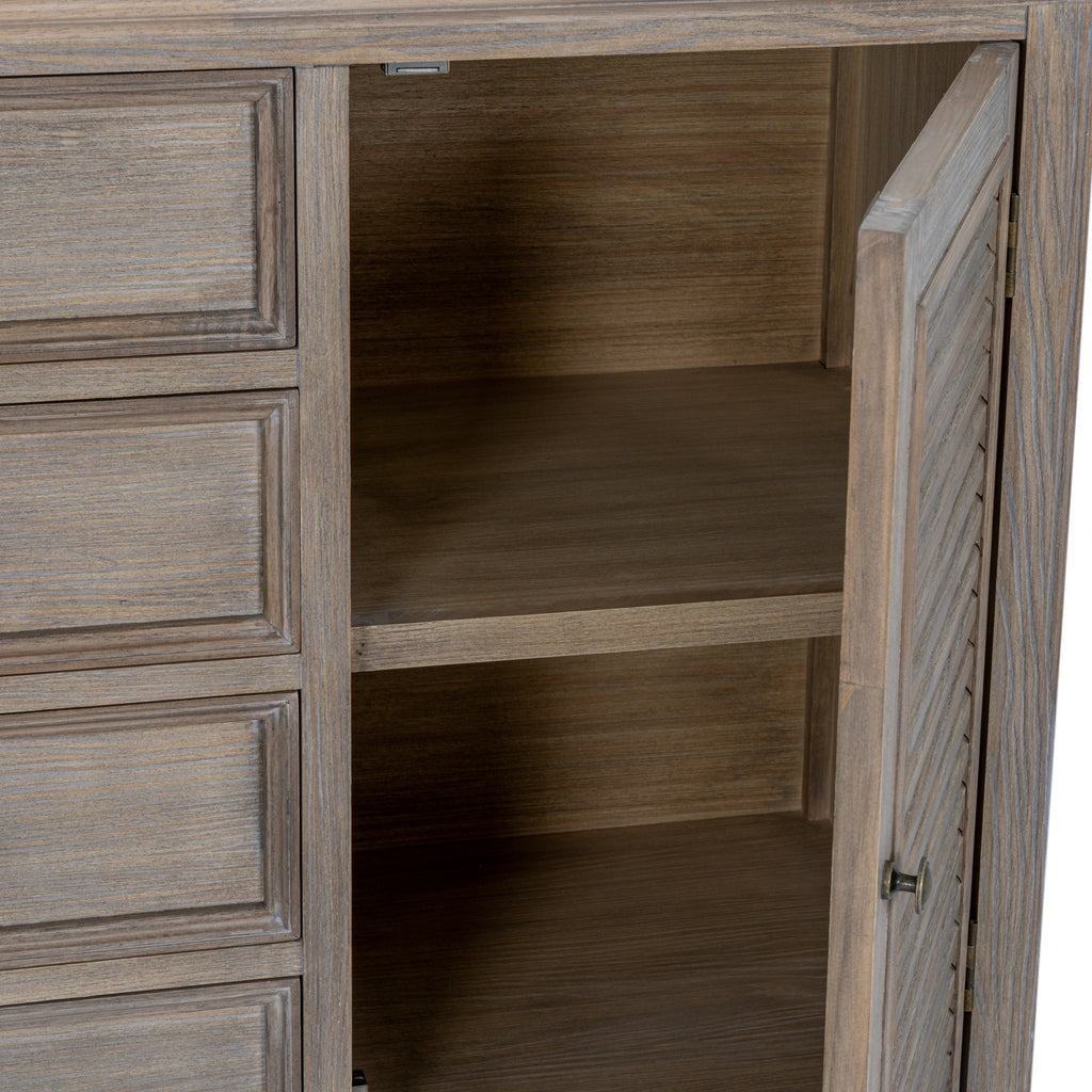Right louvred cupboard door standing open to reveal the interior shelving beside the framed drawers.