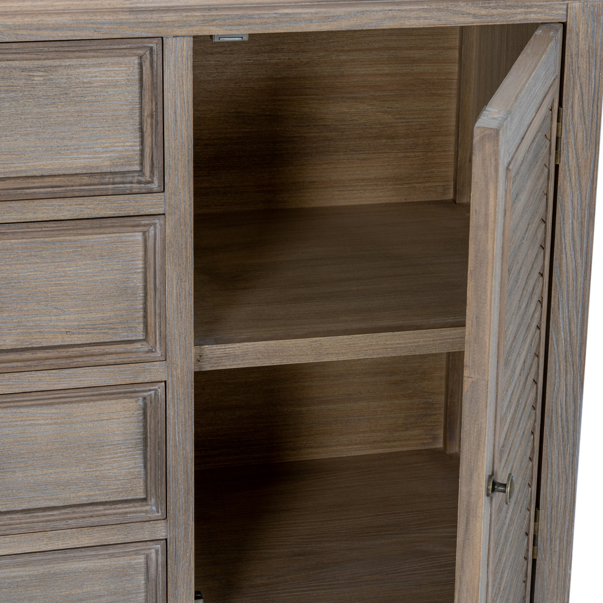 Right louvred cupboard door standing open to reveal the interior shelving beside the framed drawers.