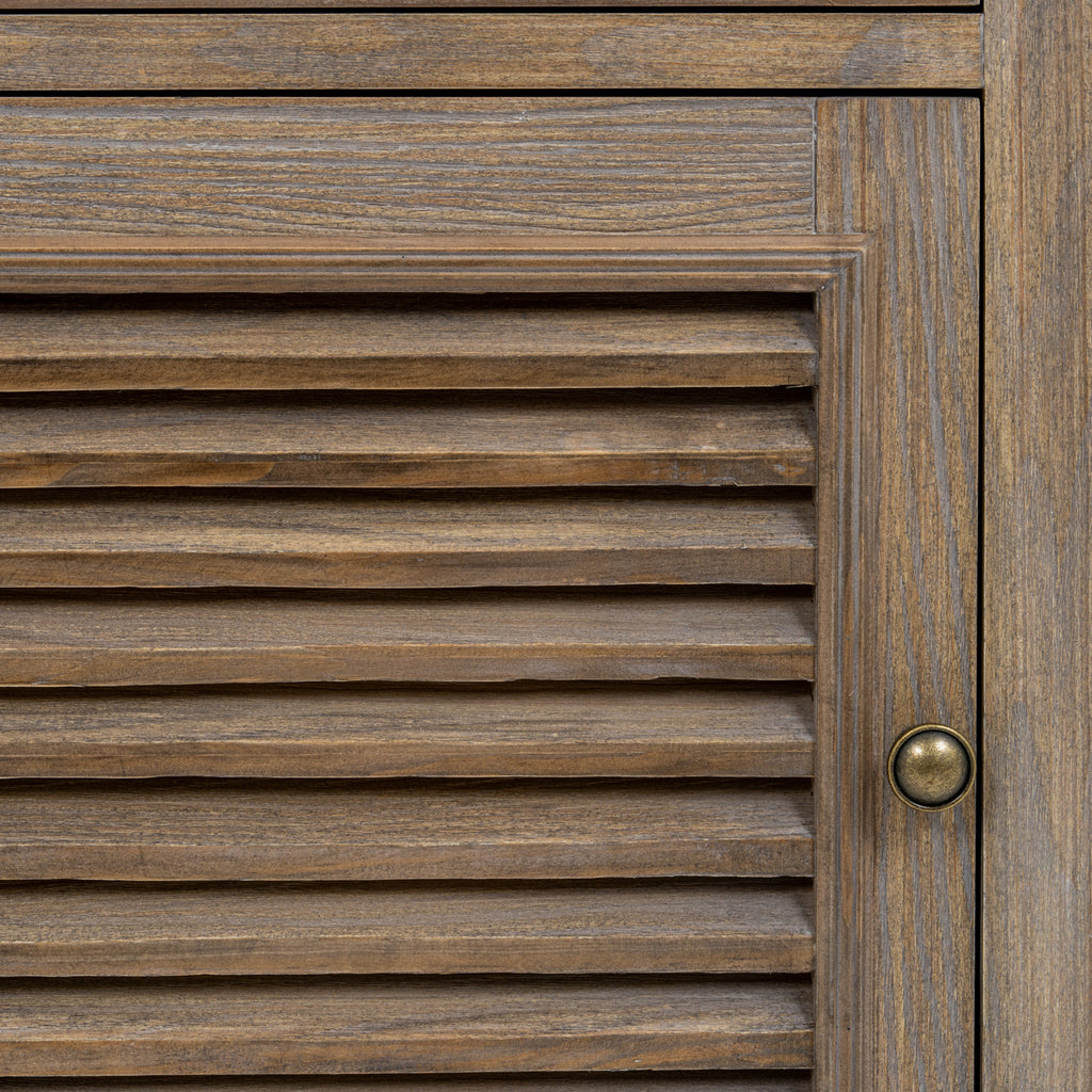 Close-up of the door's horizontal louvres, brown grain pattern, moulded frame and round metal-toned pull.