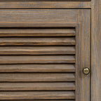 Close-up of the door's horizontal louvres, brown grain pattern, moulded frame and round metal-toned pull.