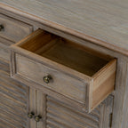 Close view of an open upper drawer showing its empty interior, framed front and round metal-toned pull.