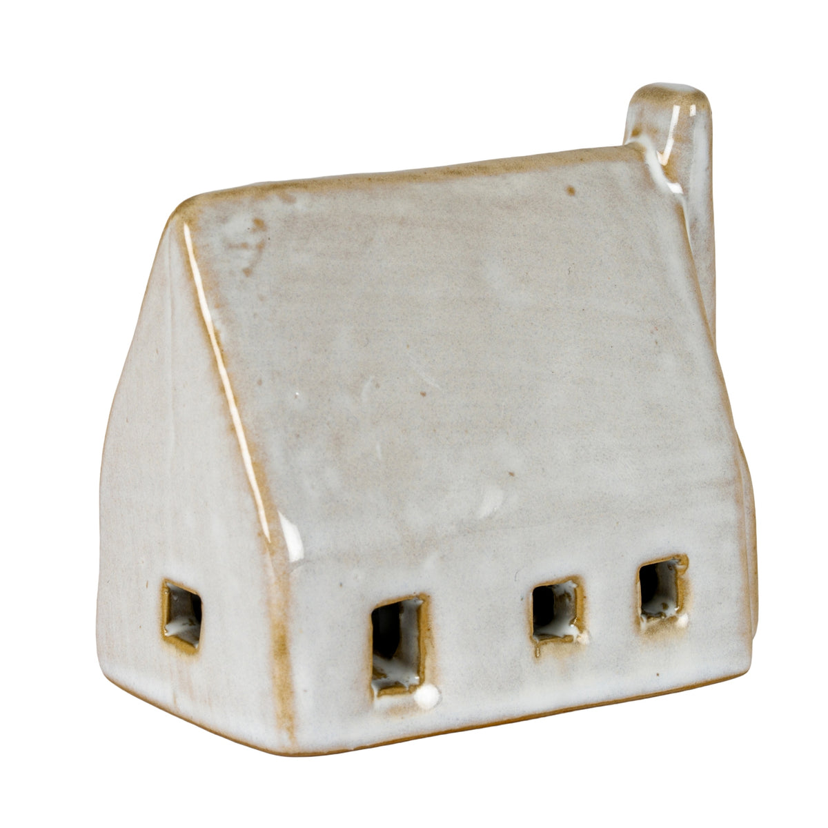 Angled view of the barn decoration showing openings on the long wall and left gable, with tan edging against its glossy off-white surface.