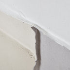 Surface detail where cream, grey and white areas meet, showing the canvas weave and curling raised edges.