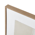 Close-up of the upper frame corner, showing its brown grain-like finish beside the white border and a textured cream shape.