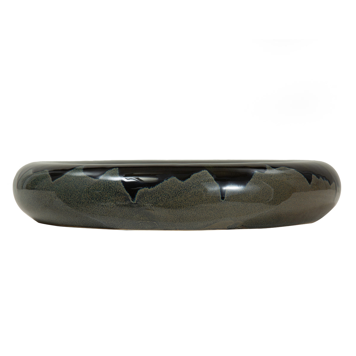Side view of a low rounded bowl with glossy blue-black glaze and mottled grey areas against a white background.