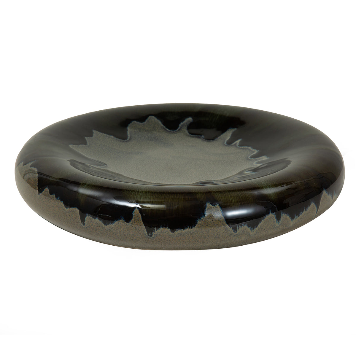 Angled view showing the bowl's shallow grey centre, rounded dark rim and irregular blue-black reactive glaze.