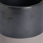 Close-up of the Lowband Planter showing its rounded rim, mottled metallic-grey surface and curved boundary above the pale lower band.